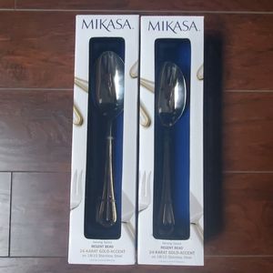 Two gold and silver serving spoons